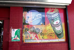Minaya Grocery, 5023 4th Ave, Brooklyn, NY with poster designs for Heineken byMaria Dominguez for Bodega Cultural NYC